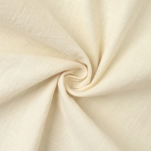 Close-up of cream-white cotton linen fabric texture with soft natural draping and weave