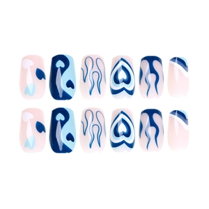 Blue flame and heart pattern press-on nails with yin-yang design on soft pink base
