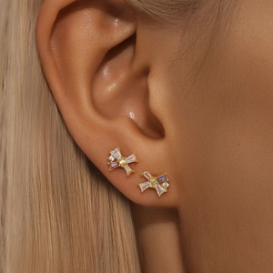 Detailed close-up of bow knot stud earrings with purple and white cubic zirconia stones