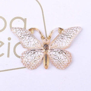 Macro shot of white resin butterfly with gold lace edges for DIY jewelry making