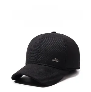 Detail of black winter baseball cap with ear protection and silver mountain logo