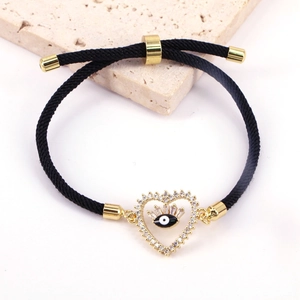 Fashionable evil eye heart charm bracelet with zircons on adjustable black woven cord
