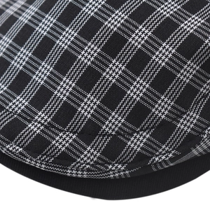 Detail shot of the woven black and white plaid texture on this classic flat cap