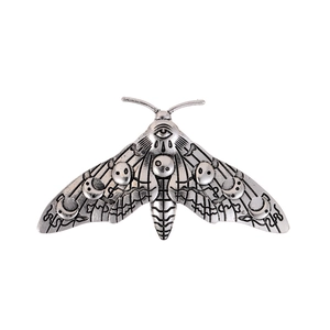 Gothic vintage silver Luna Moth brooch with moon patterns on a clean white background
