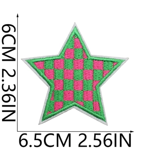 Detail of pink and green checkerboard star embroidery patch with measurement markings