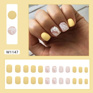 Matte lemon yellow press-on nails with marble ripple pattern for autumn style