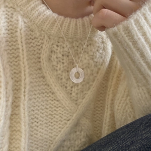 925 sterling silver geometric sunburst circle necklace worn on beige knit sweater