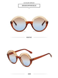 Detail view of round sunglasses with brown transparent frames and blue gradient lenses
