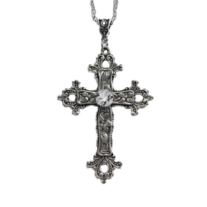 Detailed view of silver gothic cross necklace with floral pattern and center gemstone
