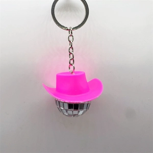 Disco ball keychain with bright pink cowboy hat and silver mirror finish on white background