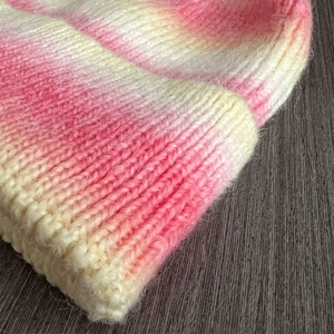Detailed macro view of the soft tie-dye gradient knit fabric and texture on the warm beanie
