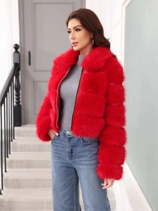 Detailed texture of high-quality red faux fur jacket with smooth zipper closure