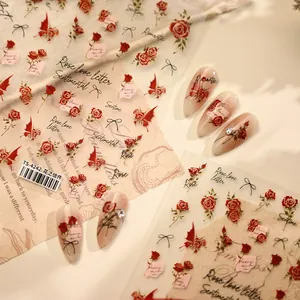 Close-up of French vintage red rose nail stickers and application on nude gradient nails