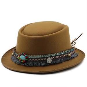 Detail of brown wool felt hat with bohemian beaded band and ethnic tassel accents