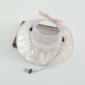 Detailed view of kids' sun hat featuring a pearlescent brim and breathable mesh lining