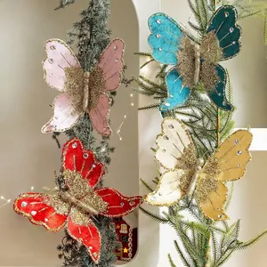 Glittery artificial butterfly ornaments with faux diamonds on Christmas tree branches