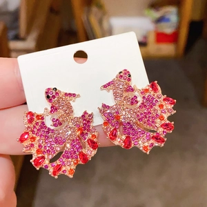 Detailed macro view of goldfish stud earrings with gradient pink rhinestones