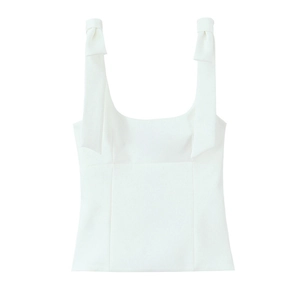 Close-up of a white sleeveless top featuring elegant bow-tie shoulder strap details