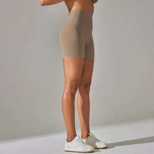 Close-up of high-waisted fitness shorts showing peach lift effect and seamless texture