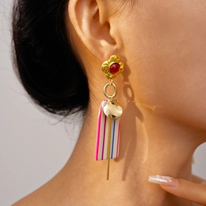 Close-up of vintage resin drop earrings with colorful stripes on a female model