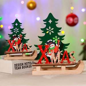 DIY wooden Christmas sleigh ornaments with painted snowman and green pine tree decor