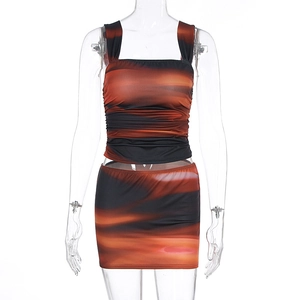 Detail of square neck ruched crop top and mini skirt in orange sunset gradient print