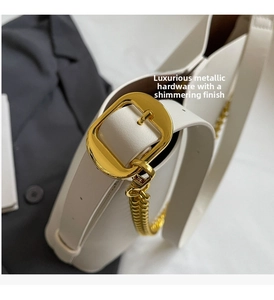 Close-up of creamy white leather tote bag featuring gold chain and hardware details
