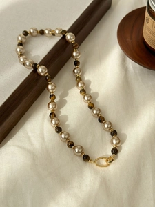 Detail of 18K gold plated tiger eye and champagne pearl beaded necklace with clasp