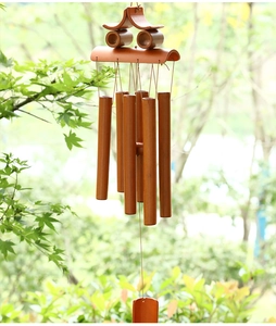 Detail of handcrafted bamboo wind chime with six brown tubes and a pagoda top design