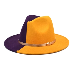 Close-up of a two-tone purple and orange fedora hat with a gold metallic buckle detail
