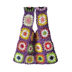 Detailed macro view of bohemian crochet tote bag showing granny square sunflower stitch