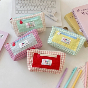 Contrast checkered high-capacity pencil cases in macaron colors on a white desktop