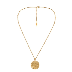 Detailed close-up of golden stainless steel coin pendant with zodiac angel relief carving