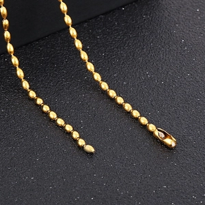 Macro shot of 18K gold stainless steel bead chain showing glossy texture and lobster clasp
