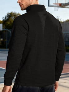 Detail view of the black waffle textured fabric and stand collar on this men's sport sweatshirt