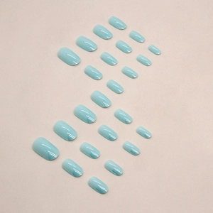 Short round press-on nails in aurora Tiffany blue finish with 24 pieces of various sizes