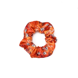 Orange Halloween scrunchie with pumpkin and ghost prints on smooth fabric for ponytails