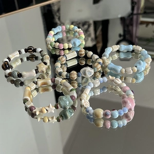 Handmade Jingdezhen ceramic beaded bracelets with starfish and bone charms in pastel colors