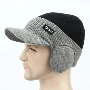 Detail of warm winter knit hat with ear flaps and SPORT logo label for men