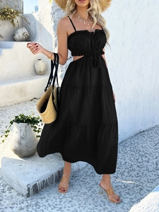 Detail of bohemian black two-piece maxi dress with cutout waist and tiered skirt
