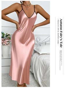 Close-up of pink satin nightgown featuring a deep V-neckline with black trim detail