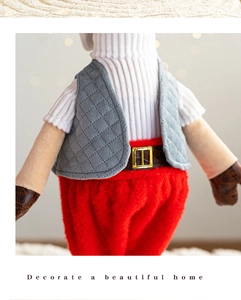 Close-up of Christmas deer doll showing knitted sweaters and quilted vest details