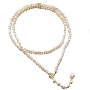 Elegant long necklace with white pearls and gold T-bar clasp featuring zircon details