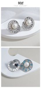 Detailed view of S925 silver shell earrings with pearls and pavé set zircons