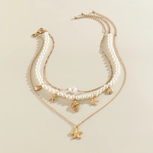 Three-layer gold necklace set featuring faux pearls with starfish and seashell charms