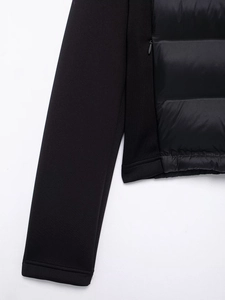 Detail of black jacket featuring quilted nylon stitching and a seamless hidden zipper