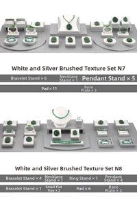 Macro view of white and brushed silver jewelry display set for necklaces and rings