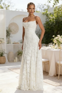 Detail showing white spaghetti strap maxi dress with 3D floral applique texture