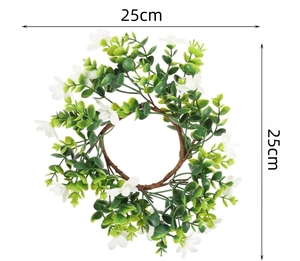 Detail view of 25cm eucalyptus candle ring with green leaves and small white flowers