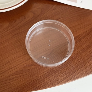 Close-up of a clear plastic lid featuring the molded No.7584 code for storage containers